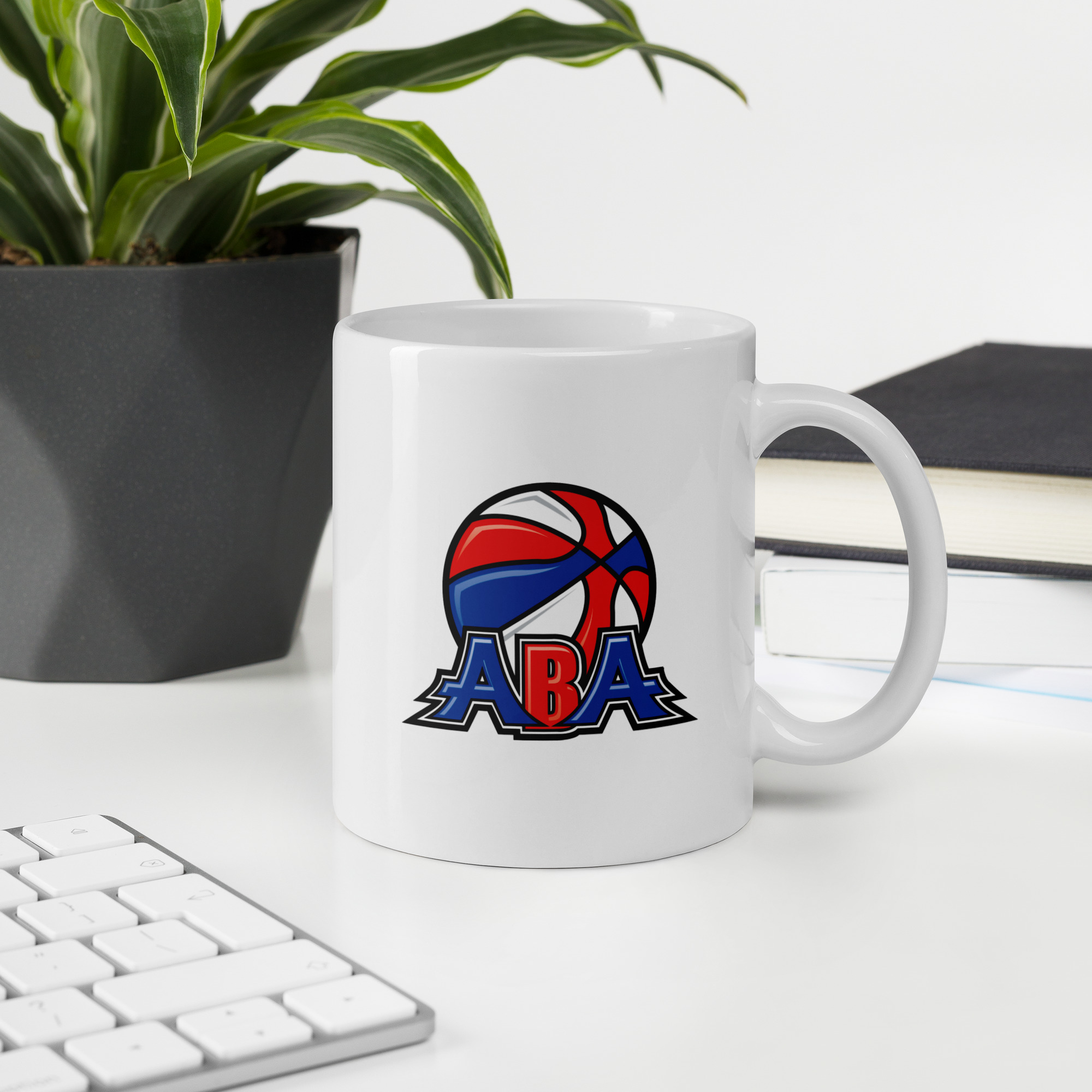 https://realabaleague.com/wp-content/uploads/2023/03/white-glossy-mug-white-11oz-office-environment-6411f05e1b5ae-1.jpg